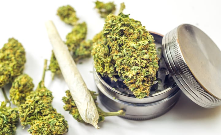 un cigarro y hojas para el consumo de cannabis medicinal